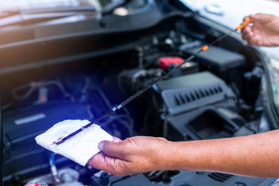 Cropped hands of man repairing car