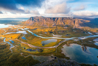 Aerial view of landscape against cloudy sky