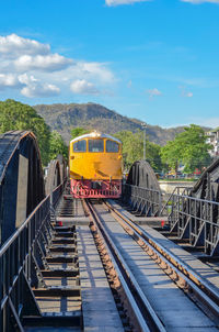 Train on railroad track against sky