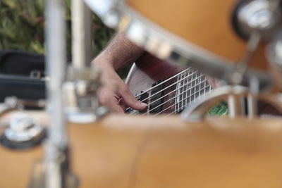 Close-up of man playing guitar