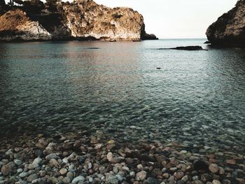 Rocks on beach against sky