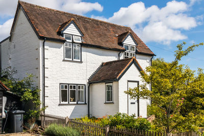 Low angle view of house and building against sky