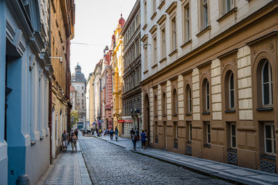 People walking on sidewalk in city