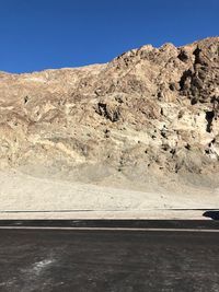 Scenic view of mountain road against clear sky