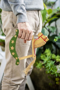 Midsection of man holding woman standing by plant