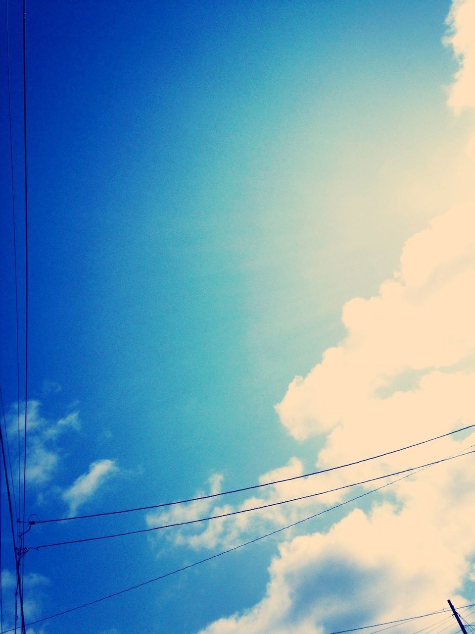 low angle view, sky, blue, power line, cloud - sky, electricity, cable, power supply, connection, electricity pylon, cloud, nature, tranquility, beauty in nature, outdoors, no people, cloudy, fuel and power generation, scenics, technology