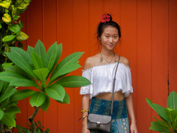 Portrait of smiling young woman standing outdoors