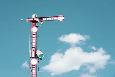 Low angle view of communications tower against sky