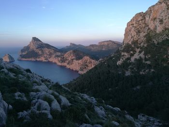 Scenic view of sea and mountains against sky