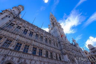 Low angle view of buildings against blue sky