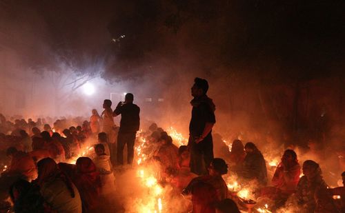 People are praying at rakher upobash in a smokey environment at barodi lokhnath brahmachari ashram