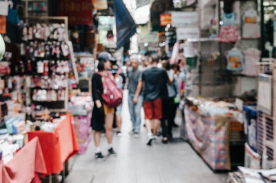 Rear view of people walking at market