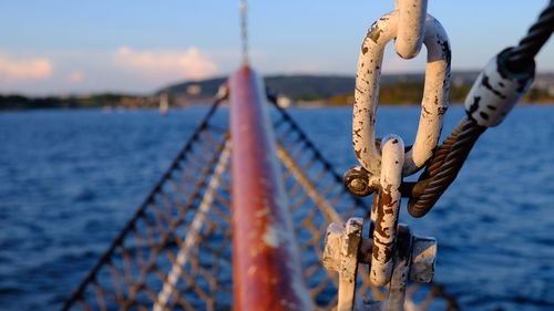Close-up of rope tied on metal railing