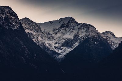 Scenic view of snowcapped mountains against clear sky