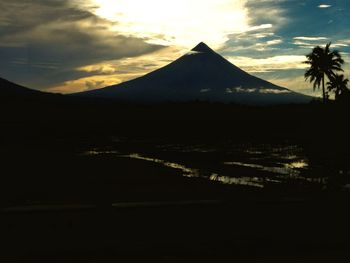 Scenic view of silhouette mountains against sky at sunset