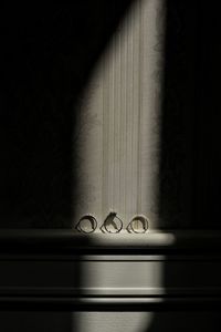 Close-up of electric lamp on table by window