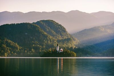 Scenic view of lake and mountains against sky