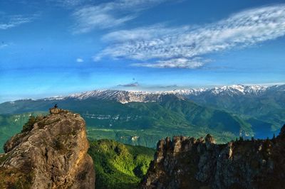 Panoramic view of mountains against blue sky