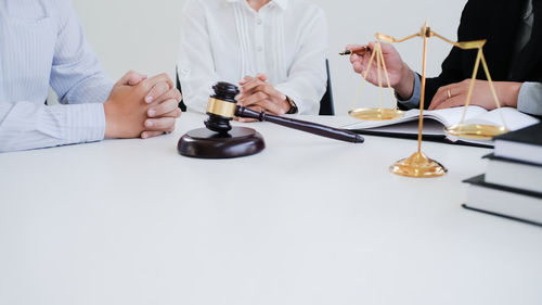 Midsection of people having food on table