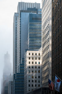 Low angle view of modern buildings against sky in city
