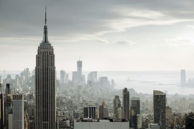 City skyline against cloudy sky