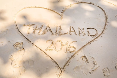 Close-up of heart shape on sand