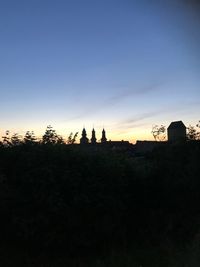 Silhouette trees against sky during sunset