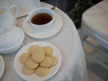 High angle view of coffee and cookies on table
