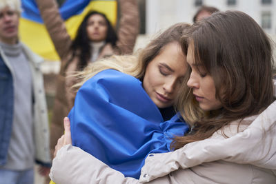 Female protesters embracing during protest