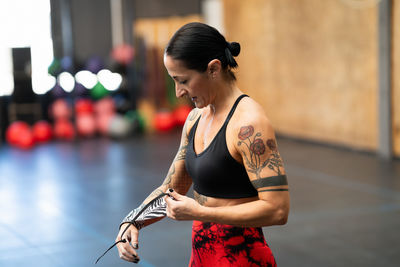 Side view of woman exercising in gym