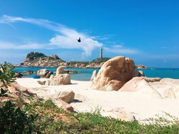 Rocks on beach against sky - ke ga lighthouse