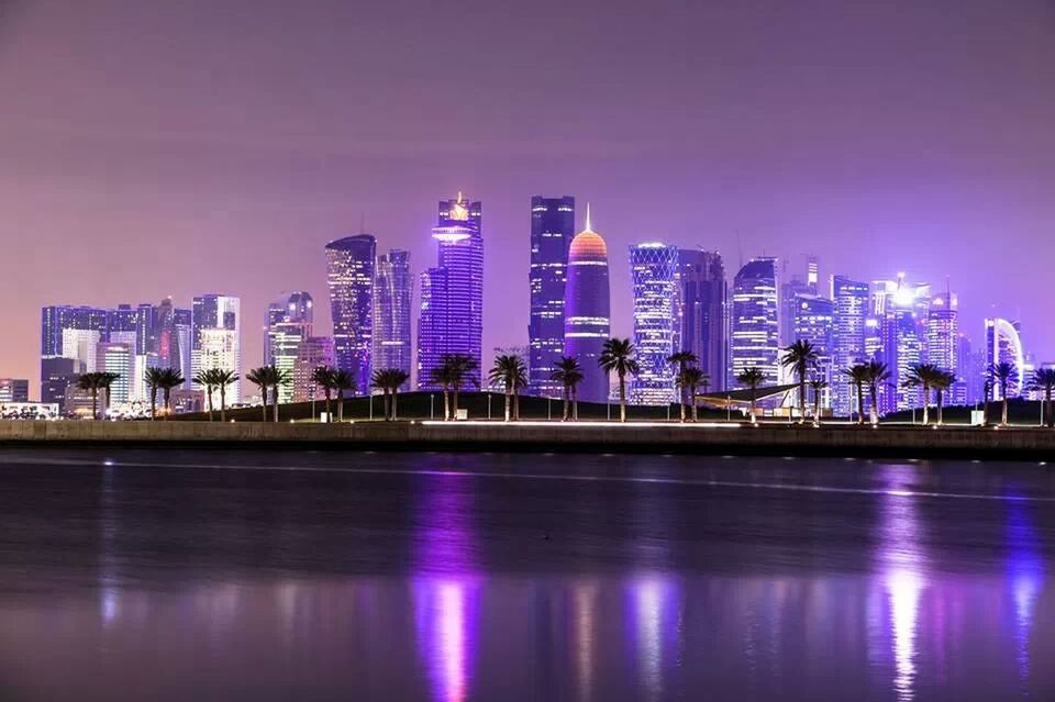building exterior, architecture, illuminated, built structure, city, water, waterfront, skyscraper, reflection, night, modern, cityscape, office building, tall - high, tower, urban skyline, sky, river, financial district, skyline