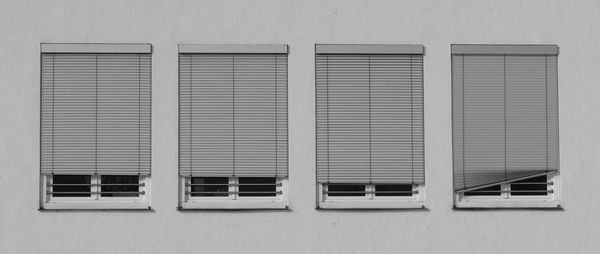 Four similar windows with blinds