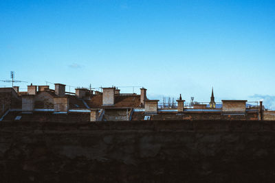 Low angle view of buildings against clear blue sky