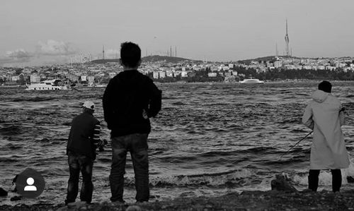 Rear view of couple standing on beach