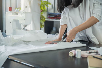 Rear view of woman working on table