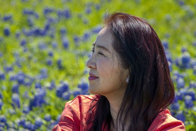 Close-up portrait of young woman looking away outdoors