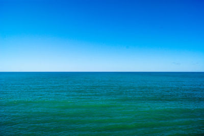 Scenic view of sea against clear blue sky