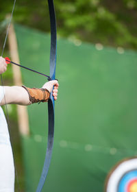 Cropped image of archer hand aiming archery bow