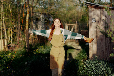 Happy woman holding bowl in farm