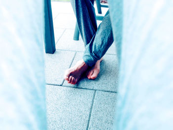 High angle view of person hand on tiled floor