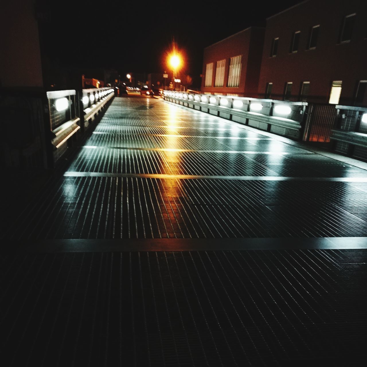 VIEW OF ILLUMINATED STREET AT NIGHT