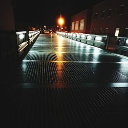 Surface level of street amidst buildings in city at night