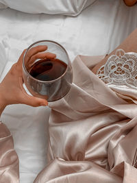 High angle view of woman holding coffee cup