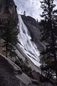 Scenic view of waterfall against sky