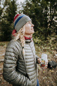 Midsection of woman wearing hat in park during winter