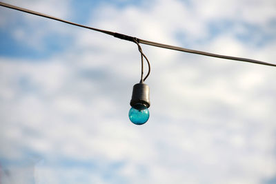 Low angle view of light bulb against sky