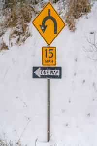 Information sign on snow covered road during winter