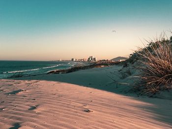 Scenic view of sea against clear sky during sunset