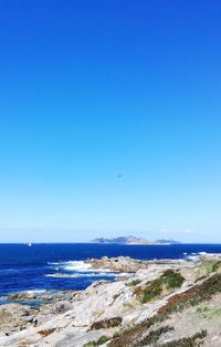Scenic view of sea against clear blue sky